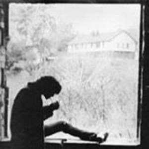 John Calabro'languidly strikes a match to light his cigarette while sitting on the unfinished window frame of the Ghost of Bayview in 1972